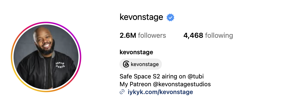 Family and observational comedian Kevin Fredericks, known as KevOnStage, smiling in a black jacket against a gray background.