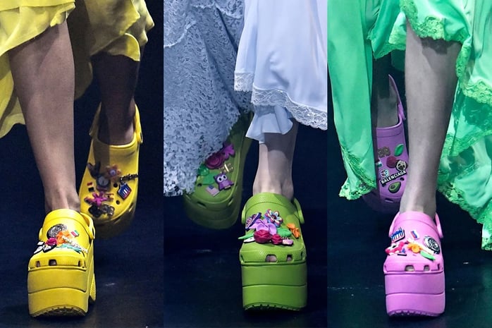 Yellow, green and purple Balenciaga platform Crocs decorated with charms.